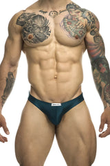 Dark teal satin briefs with a white justin simon brand tag at the waistband in classic bikini style opal green color