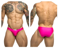 Vibrant pink high-waisted swim trunks by JUSTIN SIMON with a sleek form-fitting design and white brand tag at waistband
