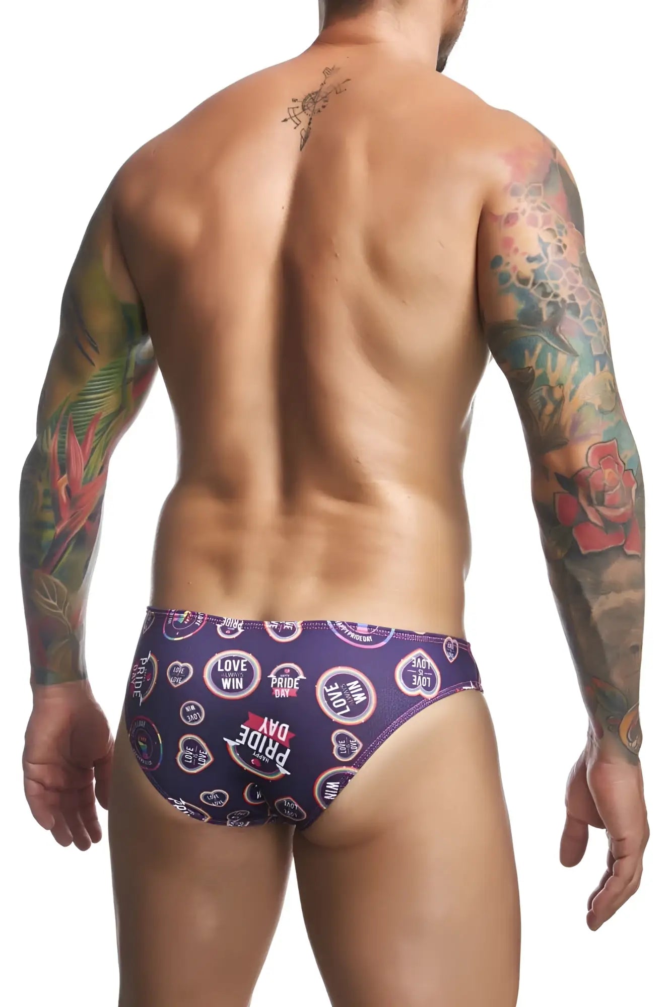 Purple patterned swim trunks with love win pride day text and heart motifs from JUSTIN+SIMON classic bikini color pride