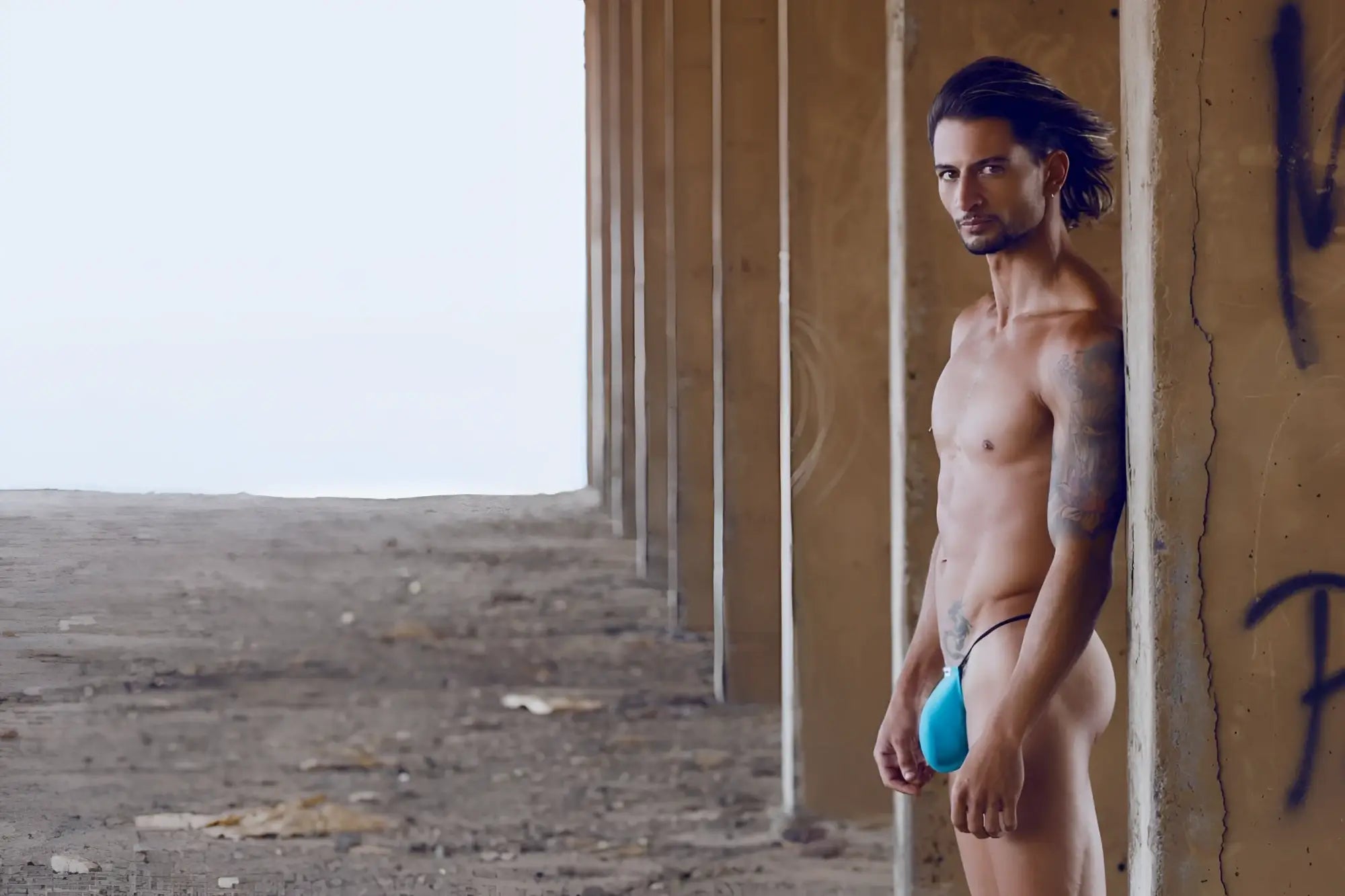 A vibrant turquoise classic g-string bulge thong by justin simon with a sleek minimalist design in form-fitting fabric
