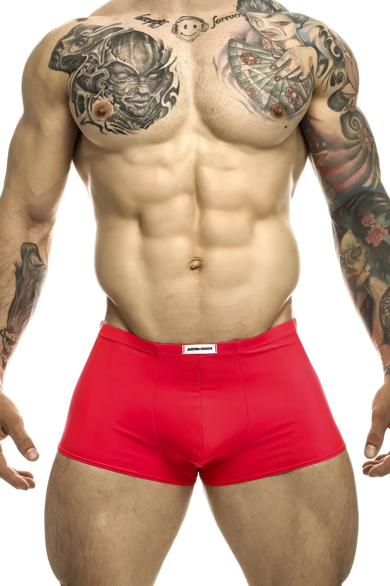 Justin+Simon classic coral red athletic briefs with a white brand tag on the waistband for active wear