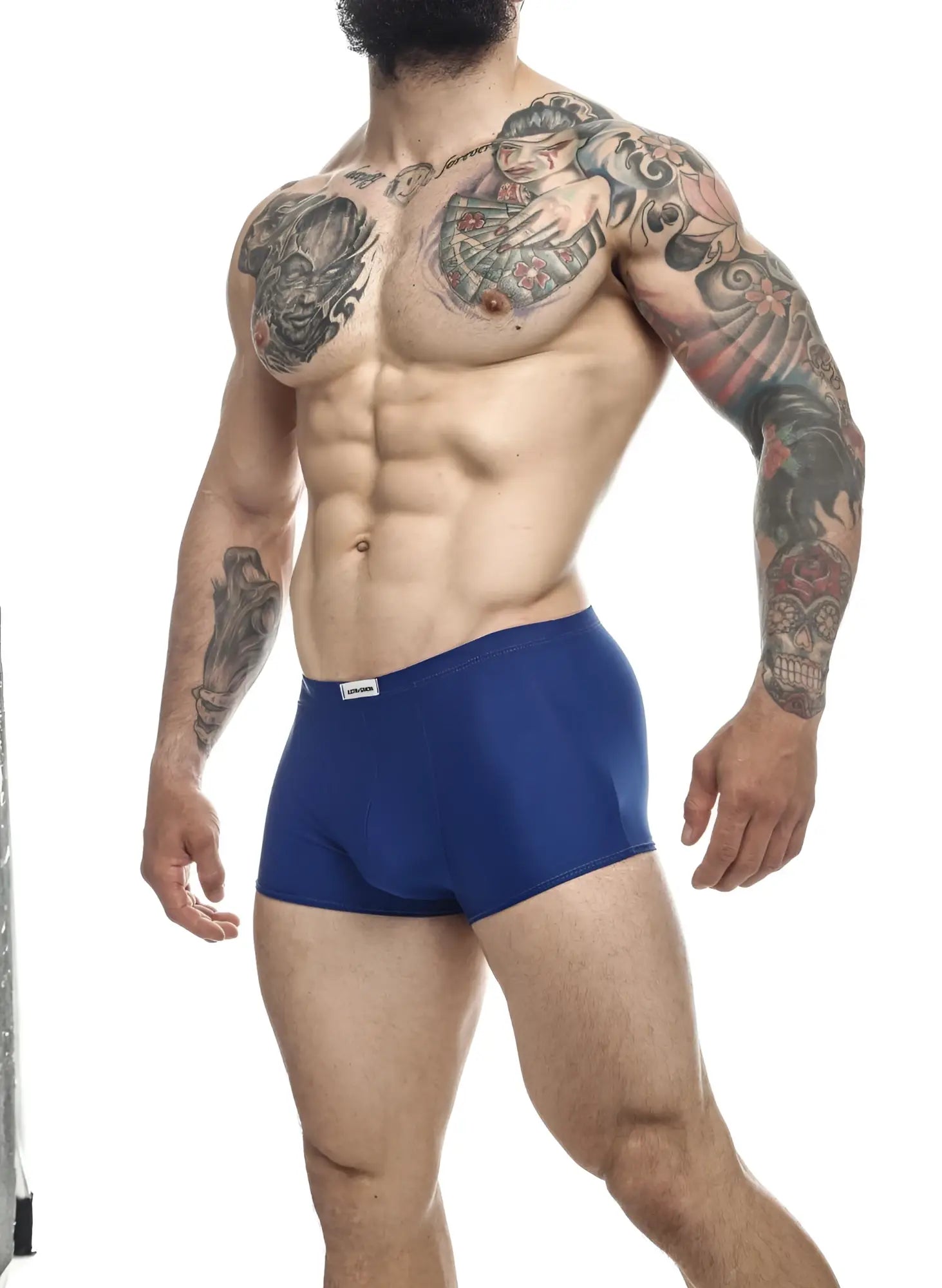 Blue justin simon classic trunks with a small white brand tag on the waistband in royal blue color