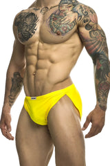 Bright yellow justin simon xsj09 running shorts with a small white brand tag on the waistband and athletic brief fit