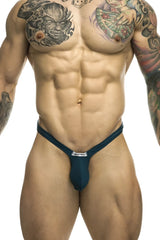 Justin simon xsjbu02 bulge thong in dark teal form-fitting fabric with small white label at the front