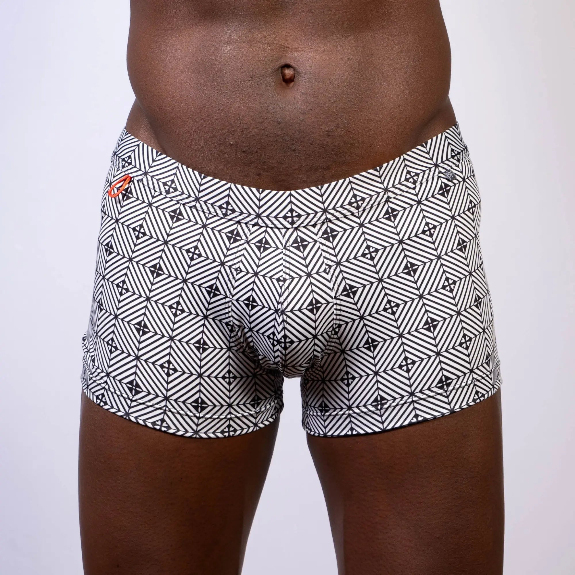 Kaleidoscope sq cut trunk boxer briefs with black and white geometric pattern and subtle orange logo waistband