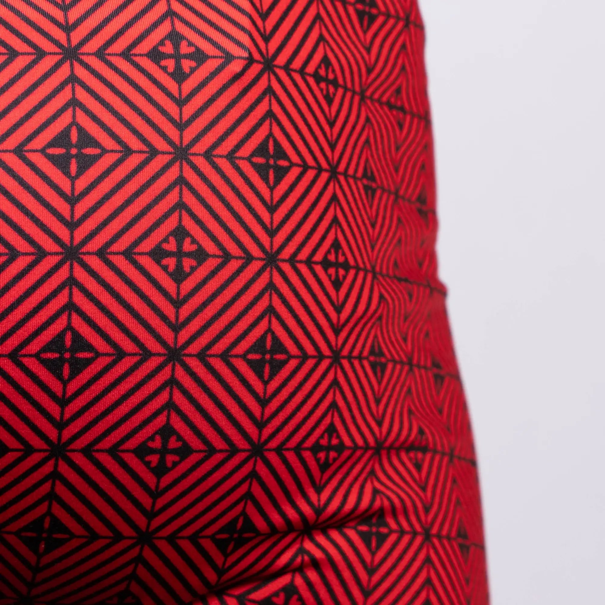 Kaleidoscope sq cut trunk in red fabric with bold black geometric interlocking diamonds and cross motifs pattern