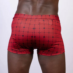 Red swim trunks with a black geometric pattern featuring a kaleidoscope design ideal for swimming and beachwear