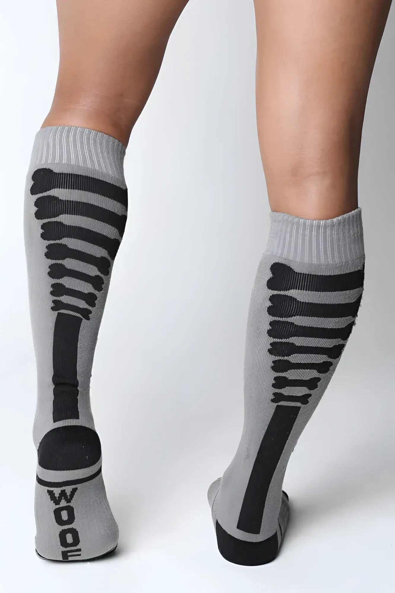 Gray knee-high socks with black skeletal design and wood printed on the heel in kennel club bones collection