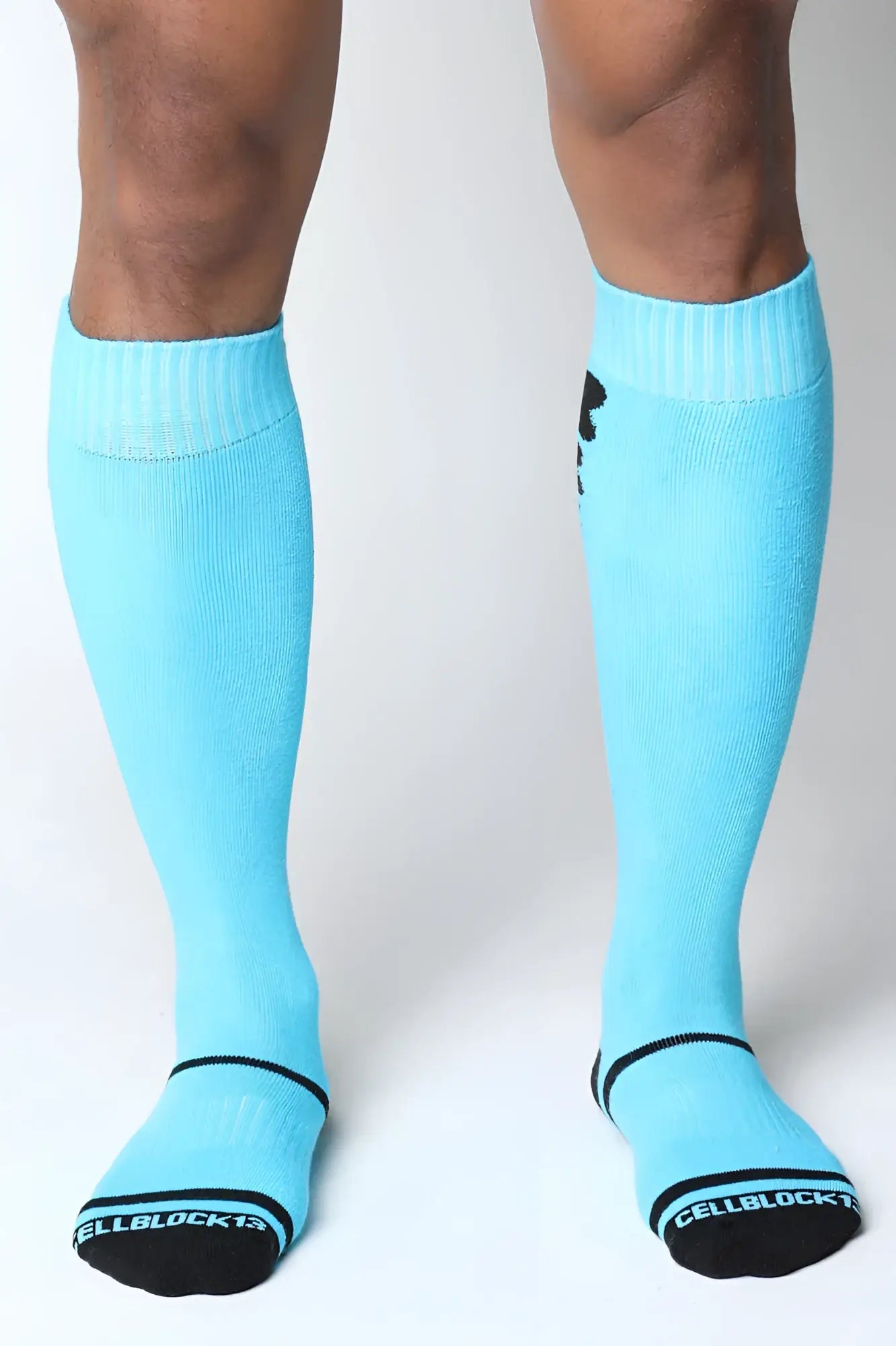 Light blue kennel club bones knee high socks with black trim and logo featuring cellblock13 branding on the sole
