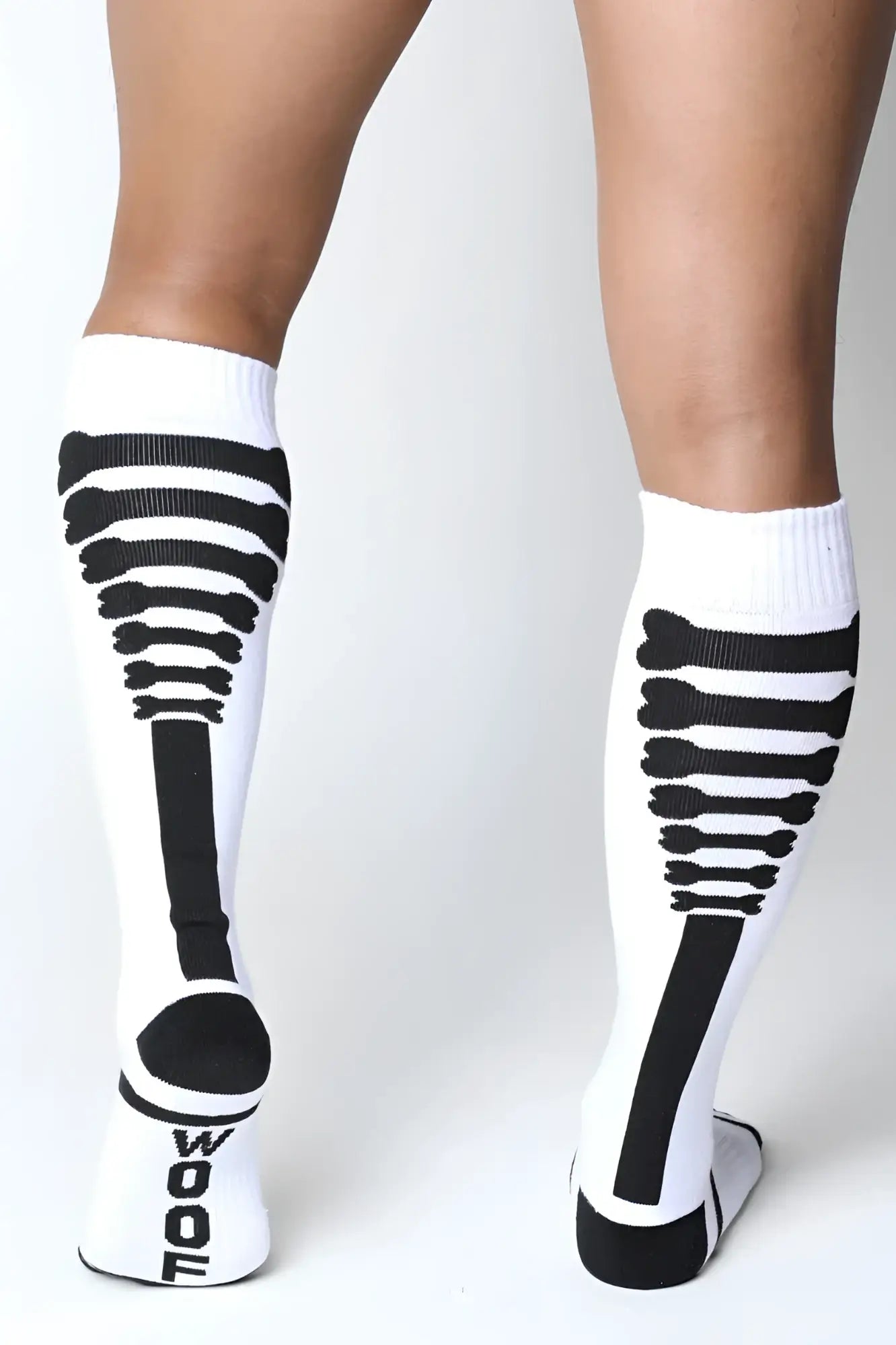 White knee high socks with black skeletal design and wool branding on heel from Kennel Club Bones collection