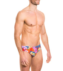 Vibrant tropical floral Kiniki Continental tan through deep waist bikini swim trunks in red blue and purple hues size S
