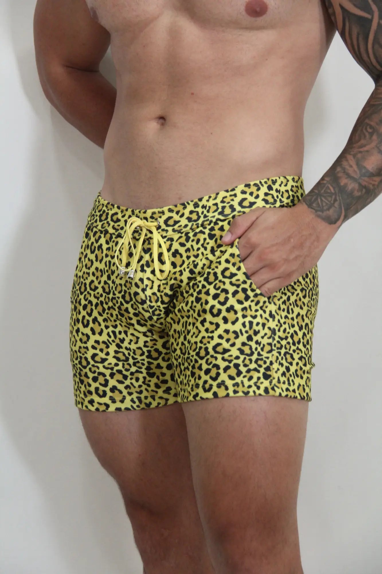Bright yellow leopard fleece short swim trunks with matching drawstring waistband for casual beachwear