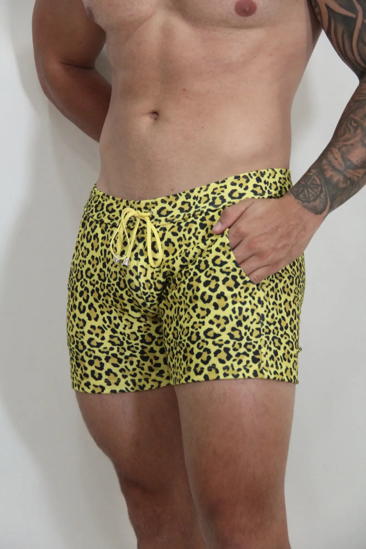 Bright yellow leopard fleece short swim trunks with matching drawstring waistband for casual beachwear