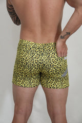 Yellow leopard-print fleece shorts with snug fit and small gray reflective patch on the side for casual wear