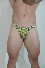 Bright yellow leopard swim thong with black spots in a stretchy fabric for stylish beachwear