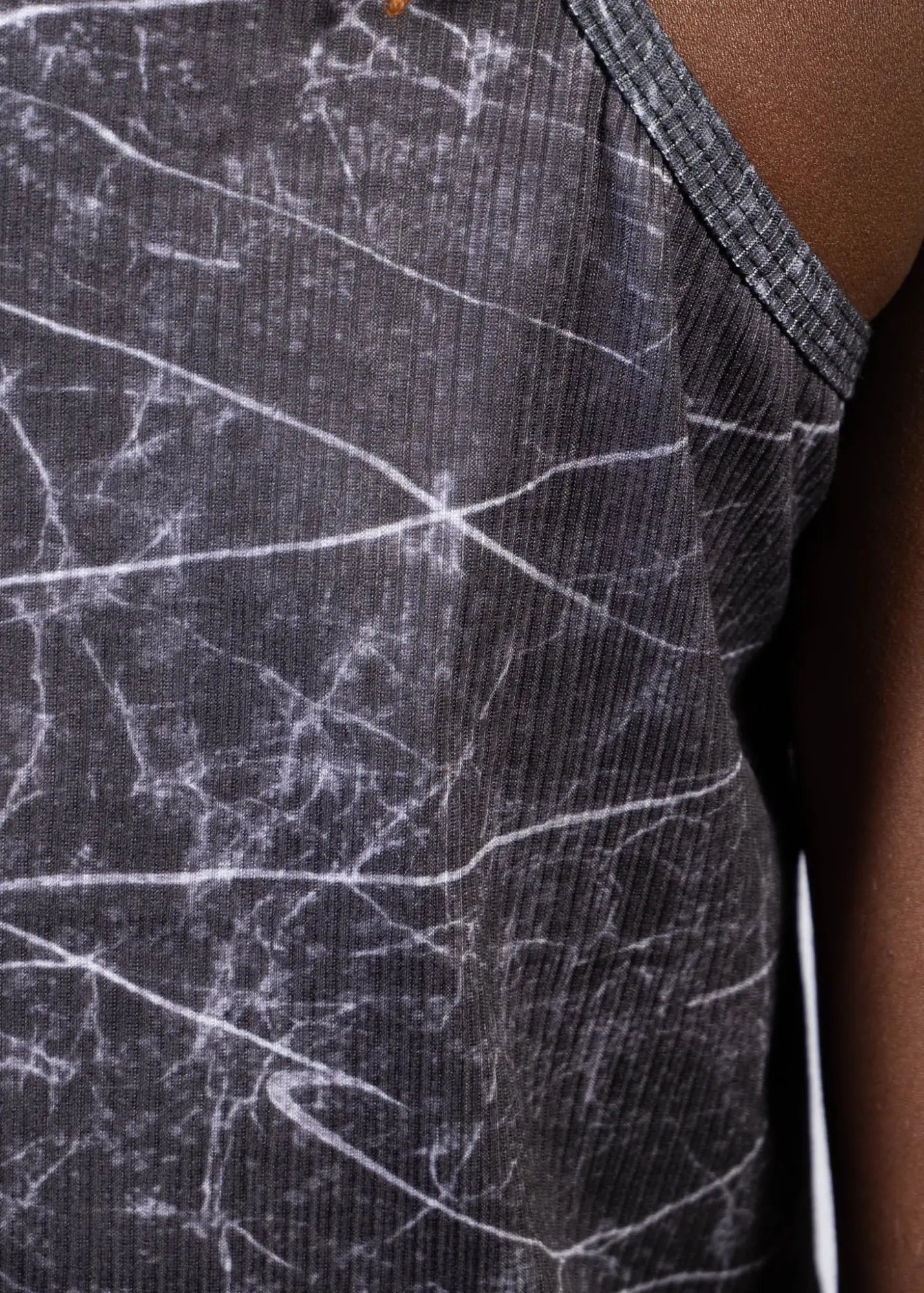 Black ribbed tank top with white marble crackle pattern and gray trim from lightning print tank collection