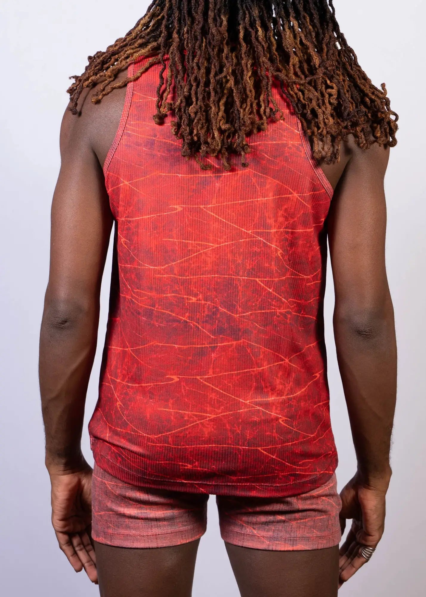 Red tank top with cracked marble lightning print in darker red and orange hues for casual wear