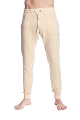 Cream-colored long cuffed jogger and yoga sweat pants with drawstring waist and side pockets in sand beige