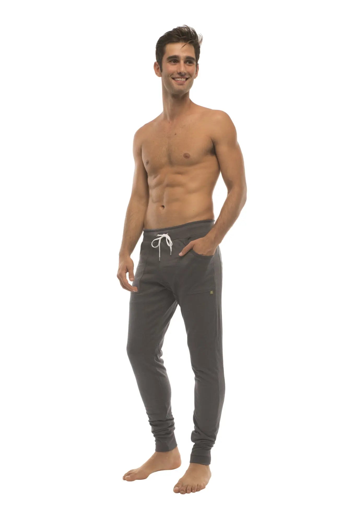 Long cuffed charcoal jogger and yoga sweat pants with white drawstrings and a gold logo on the left thigh