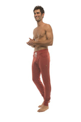Long cuffed jogger and yoga sweat pants in cinnabar red with white drawstring and side pockets for athletic wear