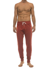 Red long cuffed jogger and yoga sweat pants in cinnabar with white drawstring waistband and side pockets