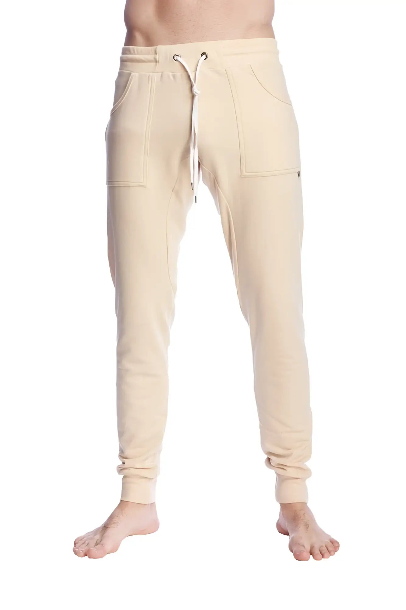 Cream-colored long cuffed jogger and yoga sweat pants with drawstring waist and side pockets in sand beige