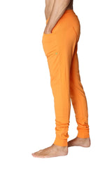 Long cuffed jogger and yoga sweat pants in sun orange with side pockets and relaxed fit for athletic wear