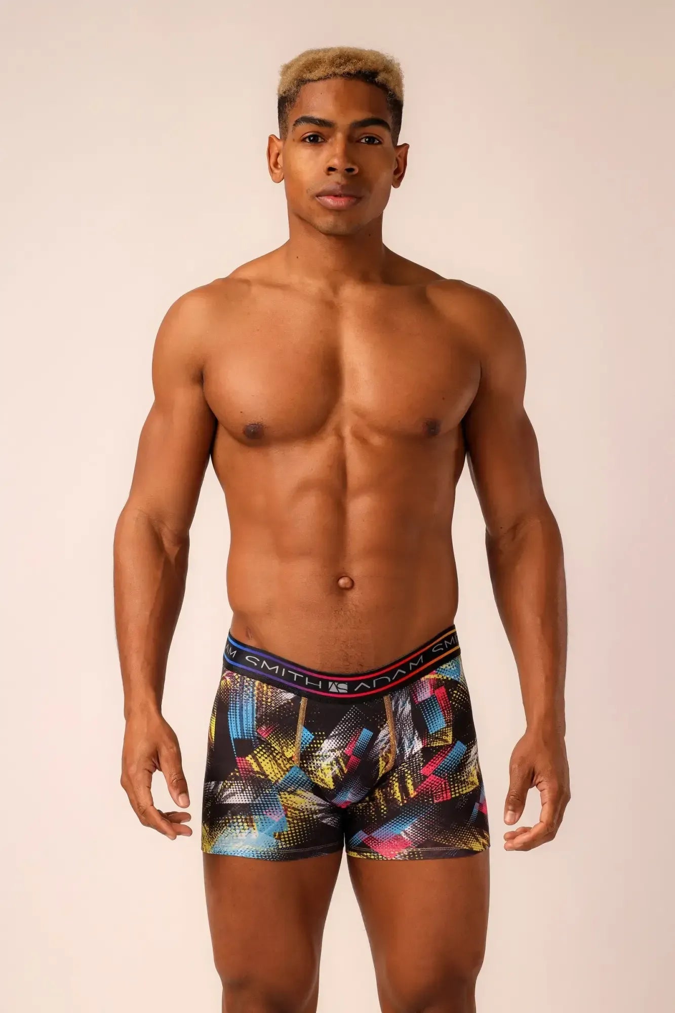 Long trunks menâs boxer briefs with multicolored geometric patterns on black base and vibrant blue yellow pink accents