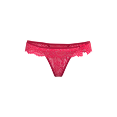 A vibrant fuchsia Magic Silk flutter thong made of lace with delicate floral patterns and a small side bow