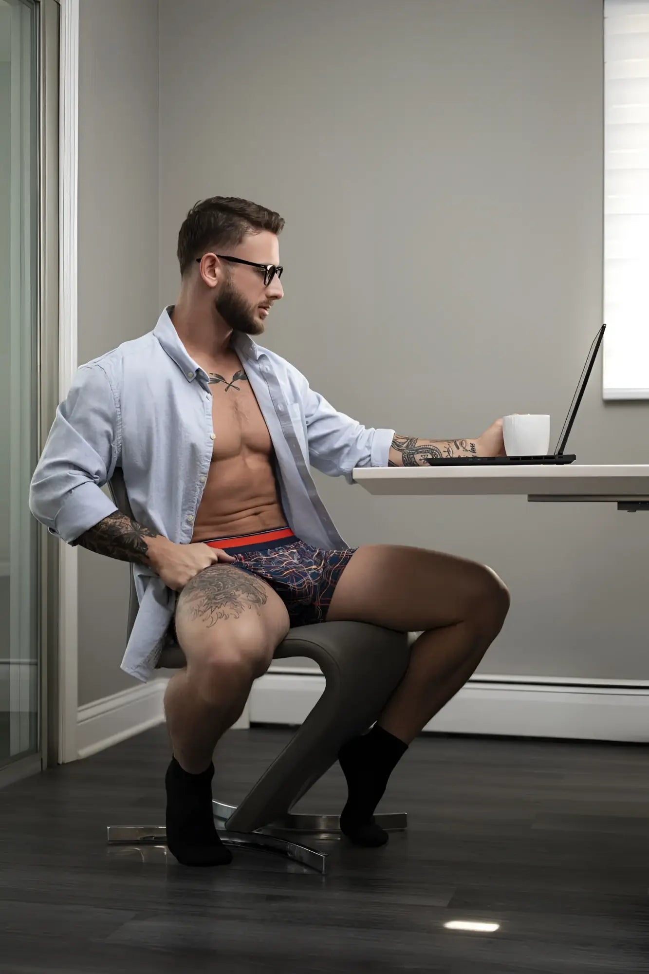 Man wearing male power soo cumfy boxer briefs in navy with red waistband featuring a patterned design
