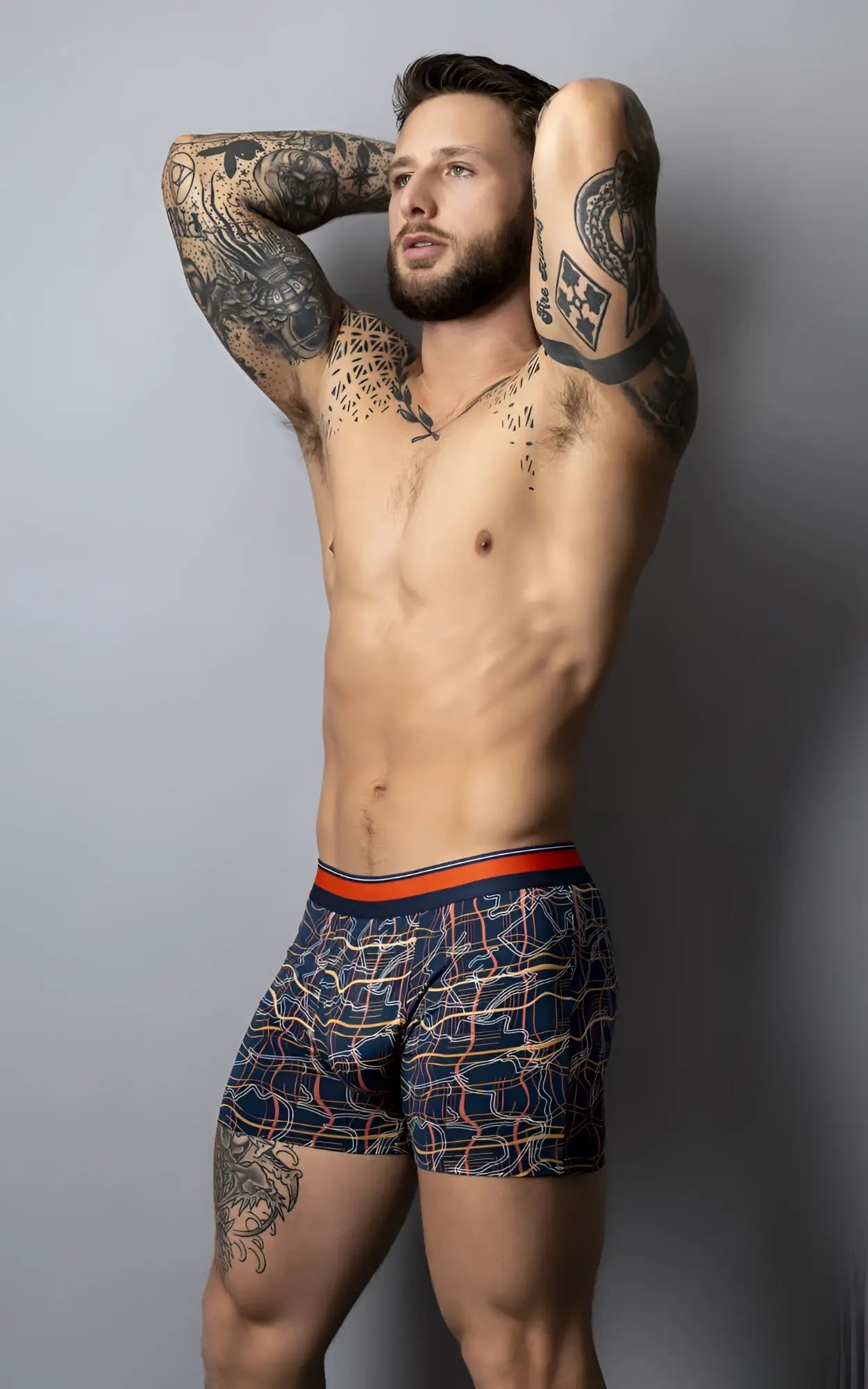 Navy blue male power soo cumfy boxer briefs with orange and white geometric pattern and orange waistband
