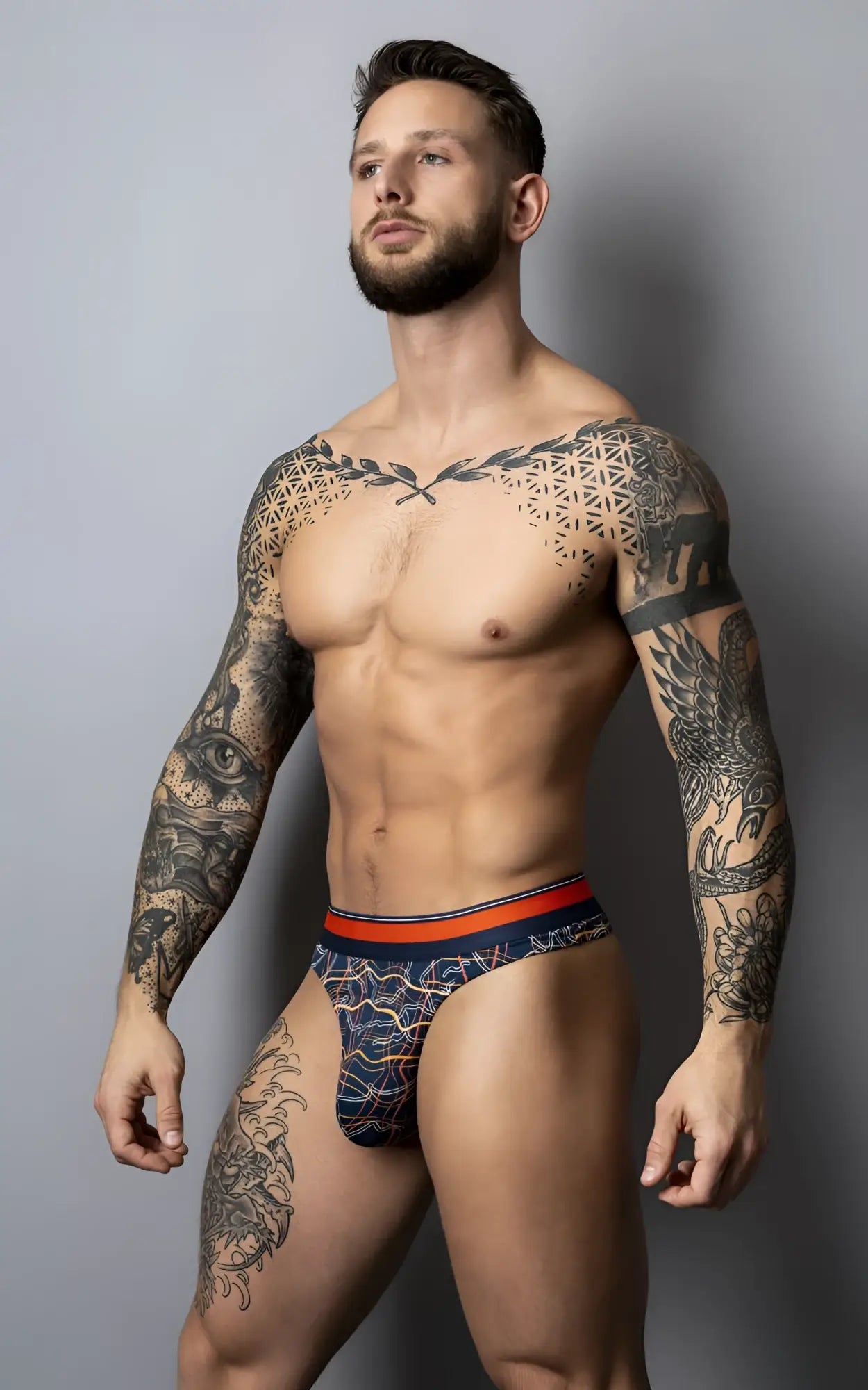Male power 412-299 soo cumfy thong in navy blue patterned fabric with an orange waistband for comfortable wear