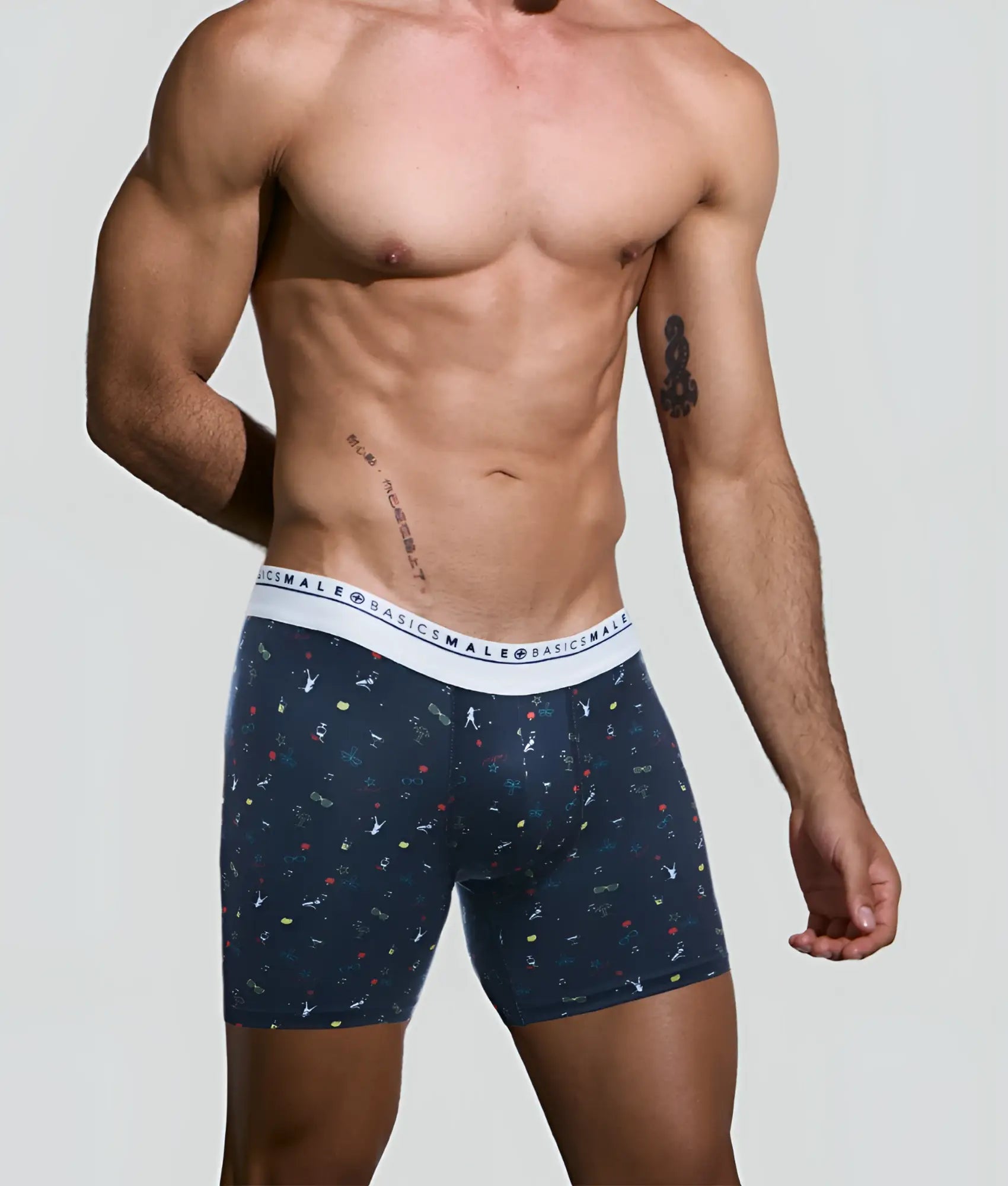 Navy blue malebasics bundle boxer briefs with white elastic waistband and colorful abstract patterns on fabric
