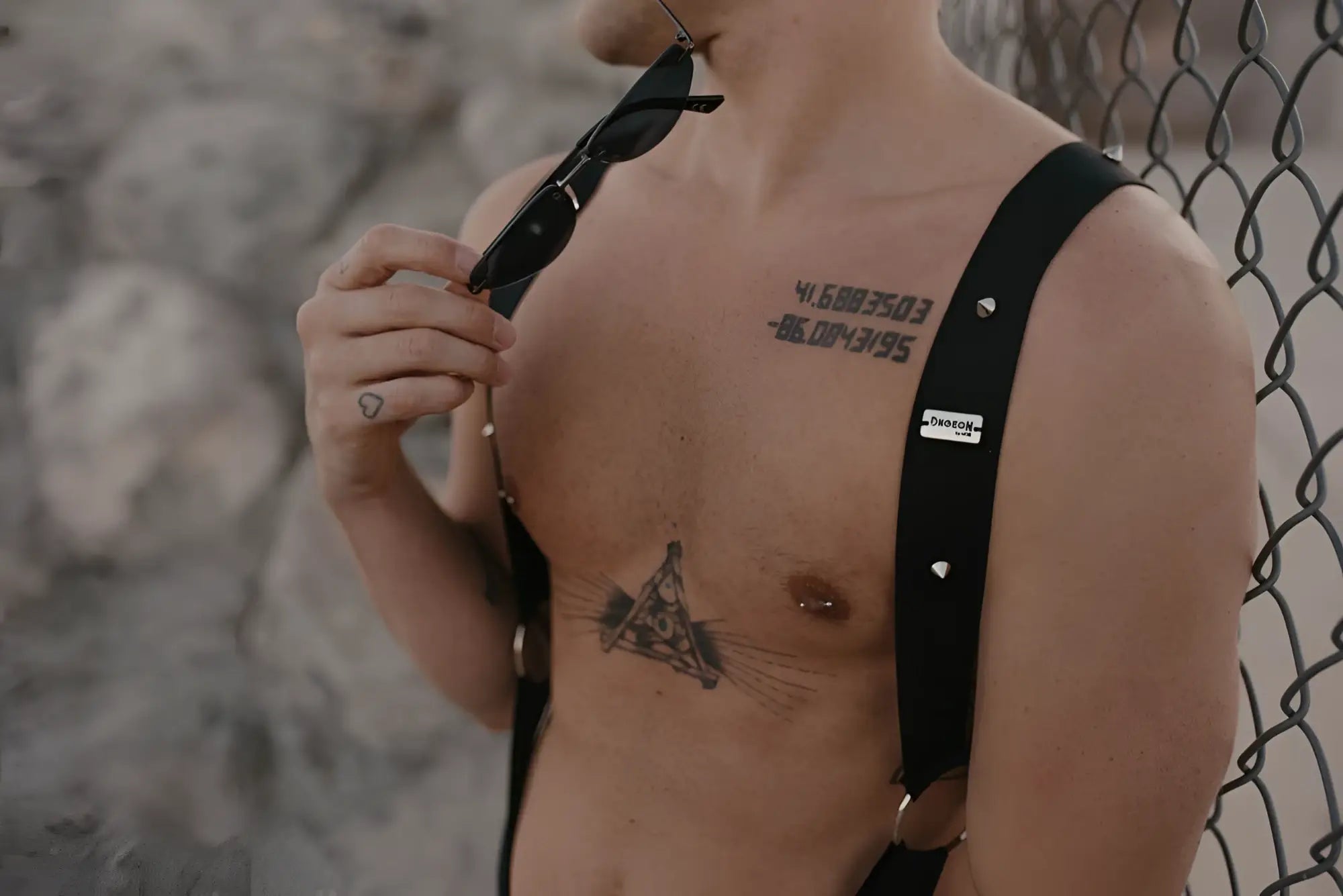 MaleBasics DMBL05 DNGEON black leather suspenders with silver studs and a small white label visible on the back side