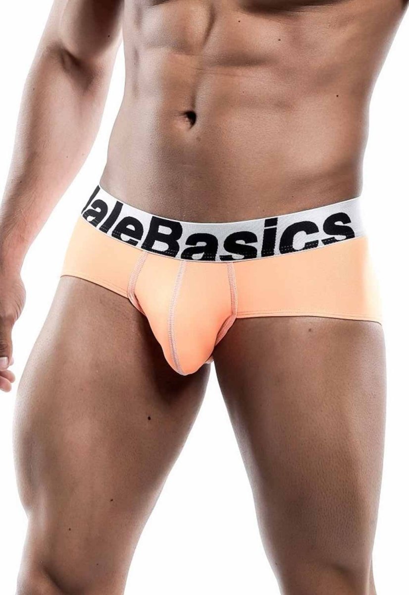 Peach-colored malebasics men’s sports performance hip briefs with white waistband and black branding are shown