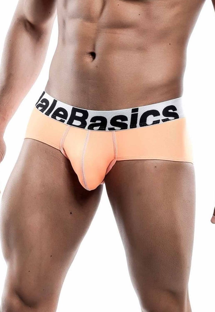 Peach malebasics men’s sports performance hip brief with white elastic waistband and black logo text