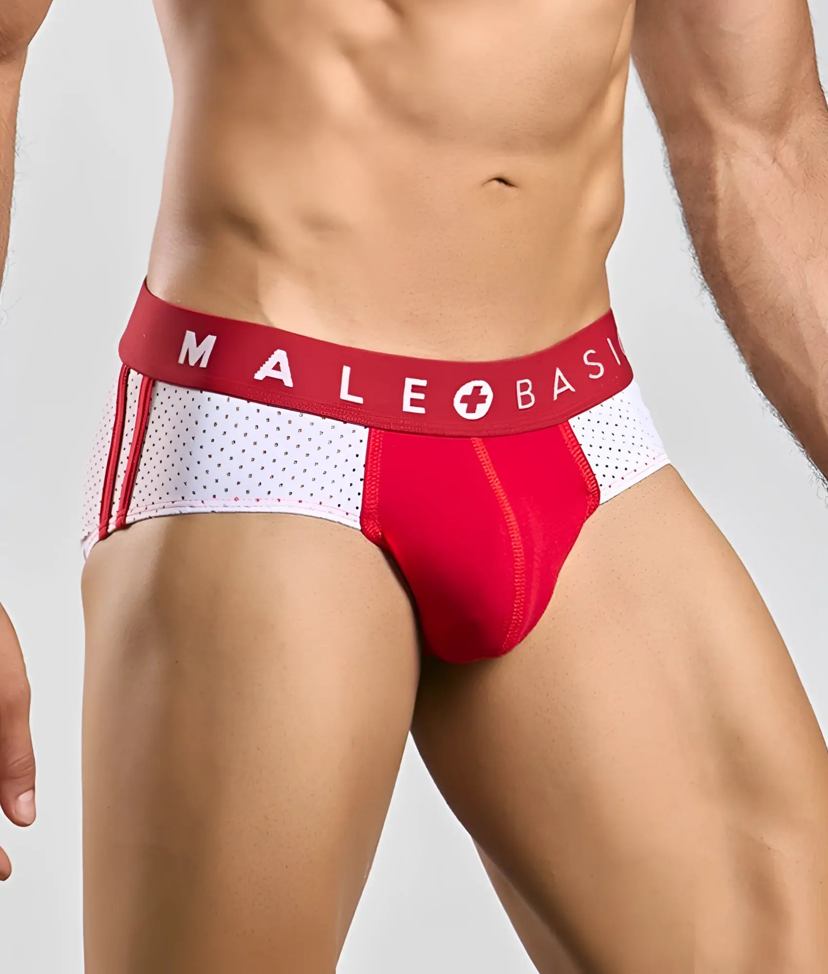 Red and white male basic athletic briefs with perforated side panel designed for active wear
