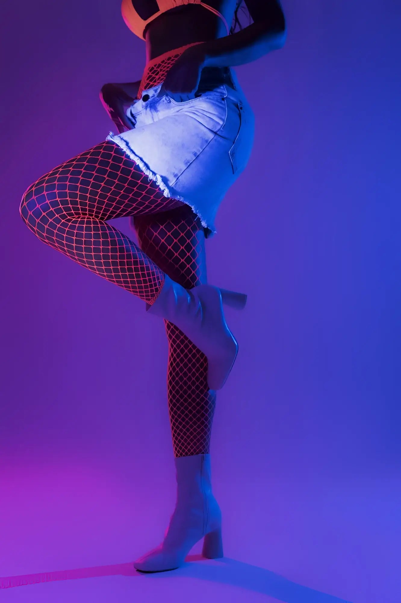 White heeled ankle boots with block heel and sleek modern design shown with neon pink mapale 1120 stocking fence net