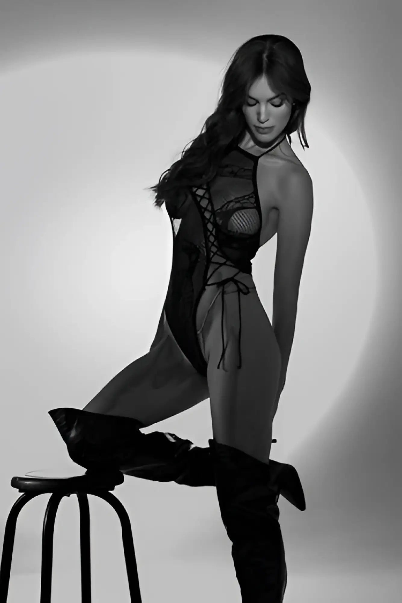 Black lace bodysuit with mesh panels and crisscross lacing detail by Mapale in black color