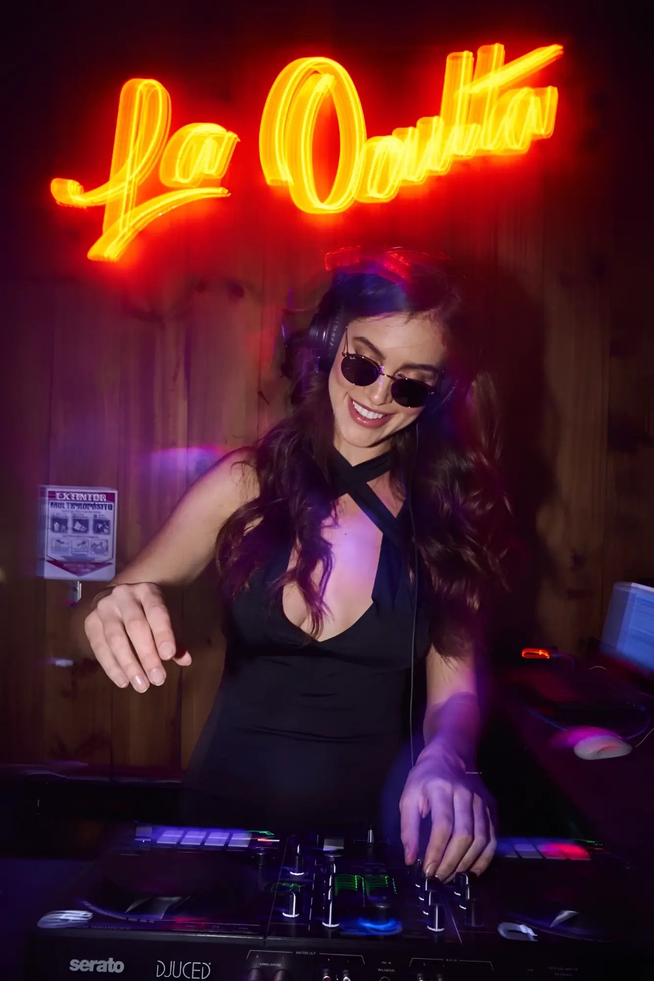 Black serato dj controller mapale 40007 with illuminated buttons and knobs under neon lighting in black color