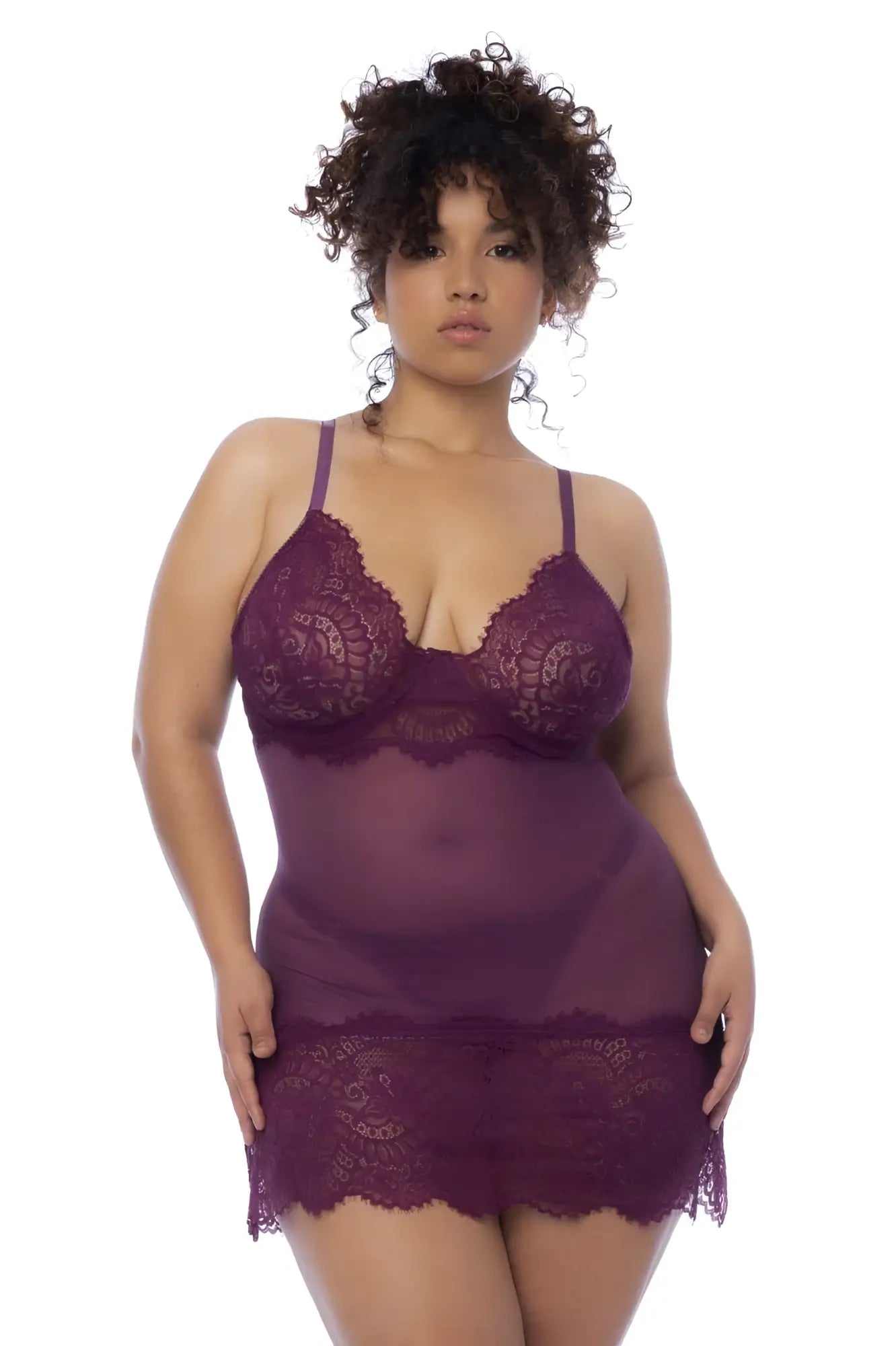 A plus-size woman wearing mapale 7554x babydoll sheer purple lace lingerie with floral patterns and delicate straps