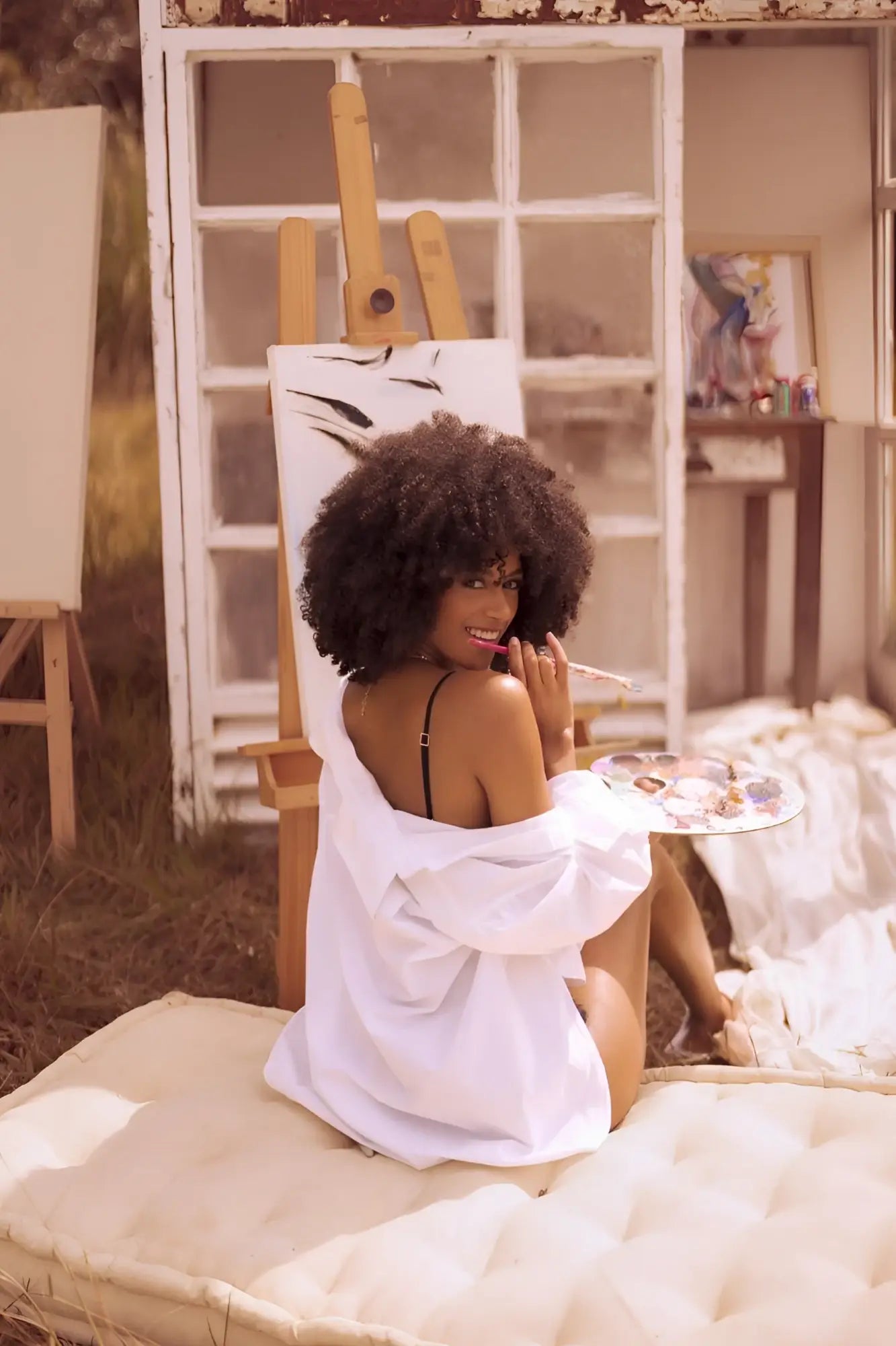 A woman wearing mapale 8864 two piece set night butterfly in black lingerie with an oversized white shirt sits on a cushion