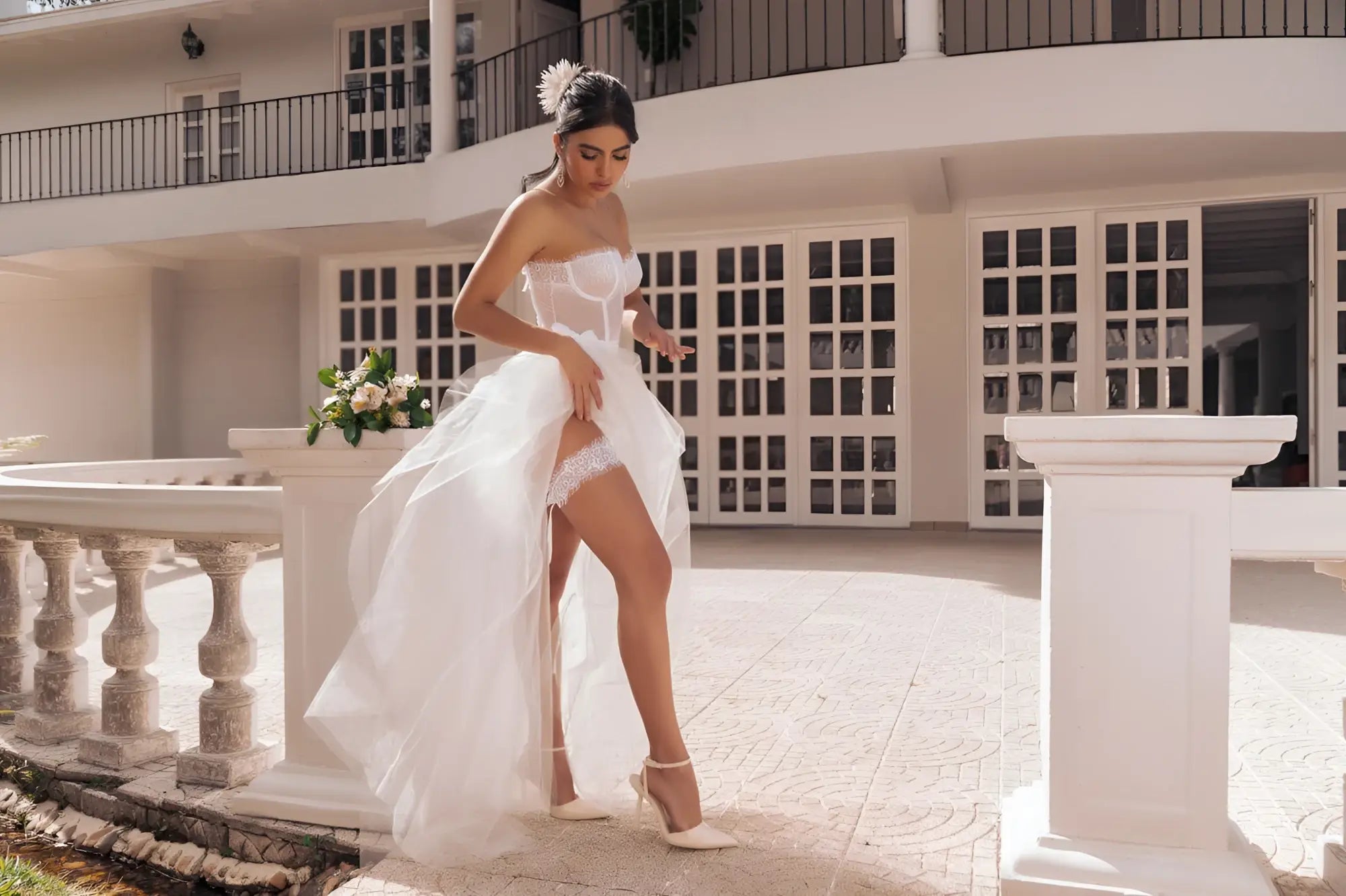 A flowing white mapale 8933 bridal gown with a high slit and delicate lace trim in a four piece set