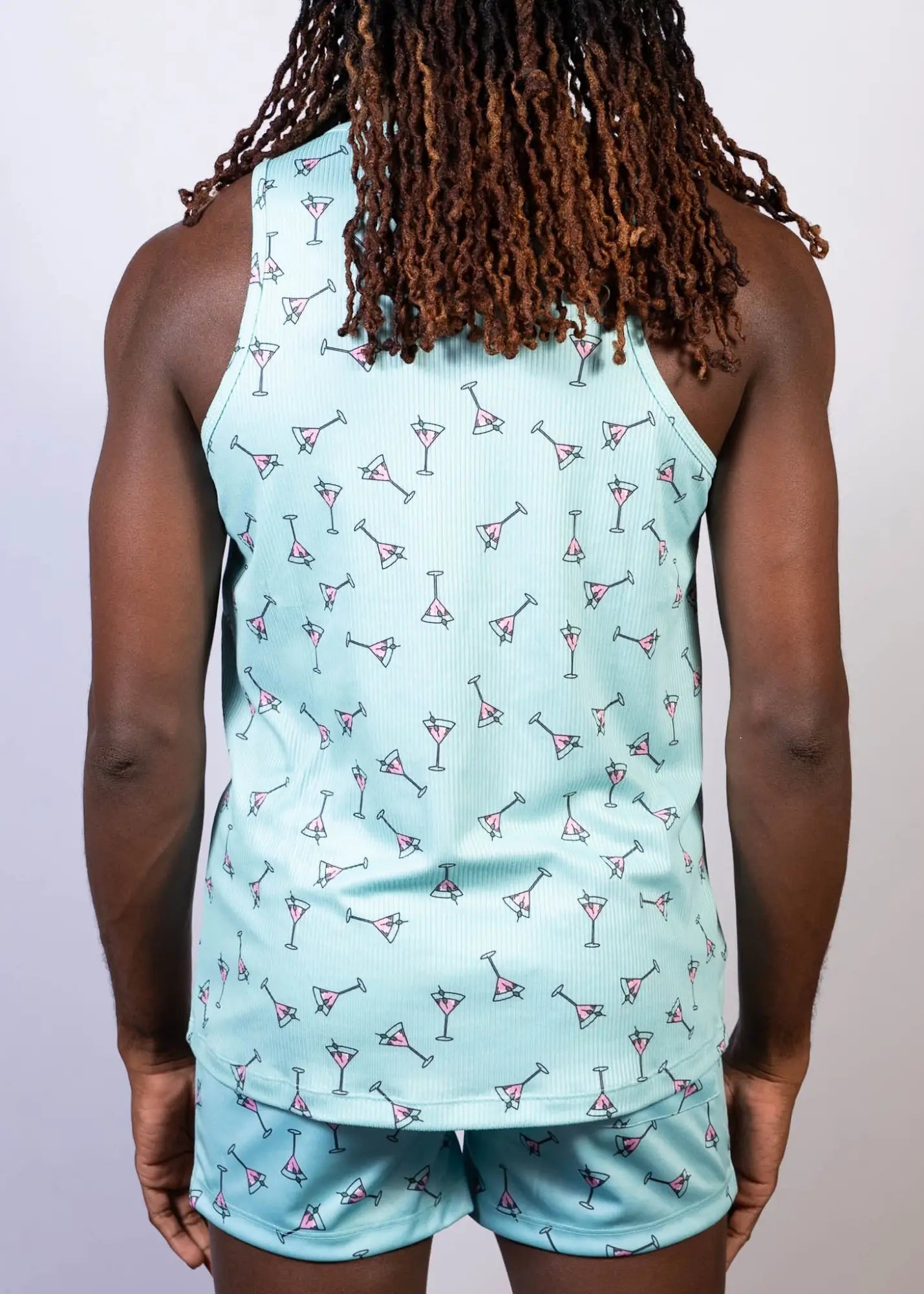 Light blue tank top with a repeating pink and black martini glass print in the martini print tank collection