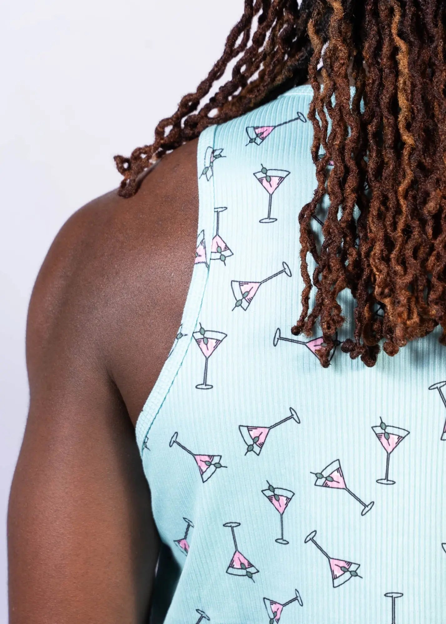 Light blue ribbed tank top with playful pink martini glass pattern outlined in black called martini print tank