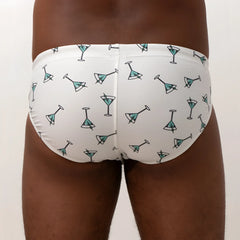 White martini swim brief featuring teal martini glass pattern with black outlines perfect for beachwear