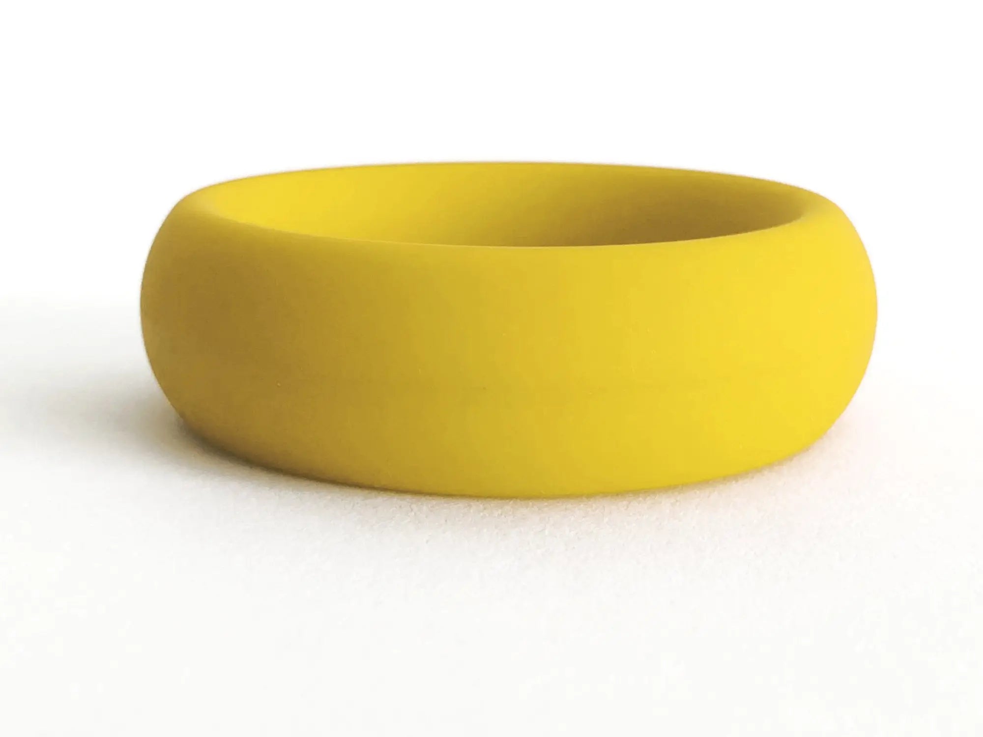 A smooth solid yellow silicone ring with a minimalist design from meat rack collection