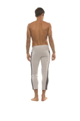 Mens light gray form-fitting capri yoga pants with dark gray vertical side stripes and zippered pockets