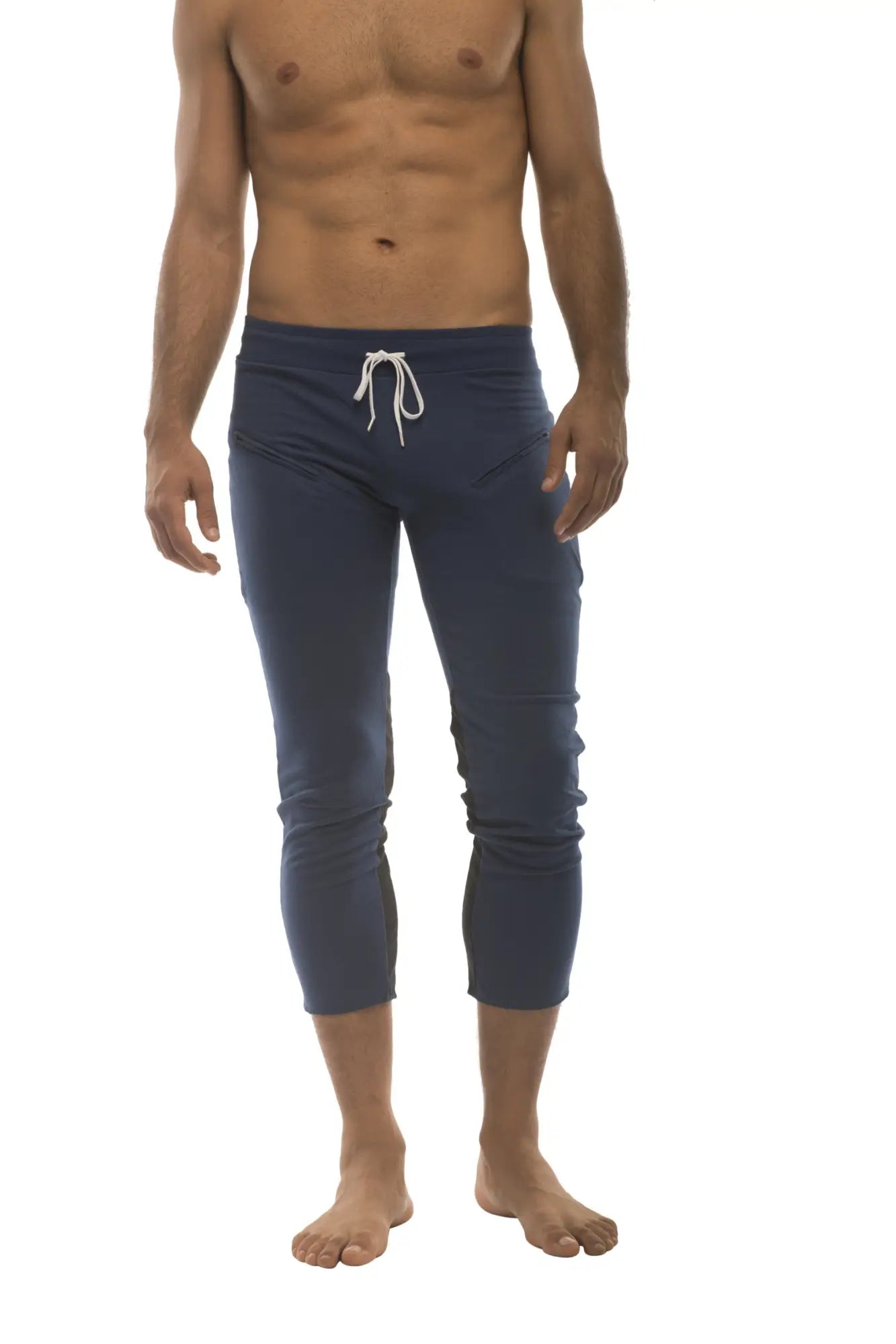Mens navy blue capri yoga pants with white drawstring waistband and 4/5 zipper pockets for athletic use