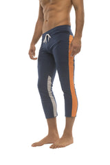 Mens navy blue athletic capri yoga pants with orange and white side stripes and 4/5 zipper pockets